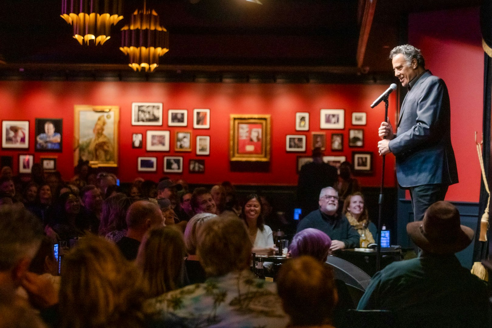 Comedian performing on stage at Brad Garrett's Comedy Club in Las Vegas.