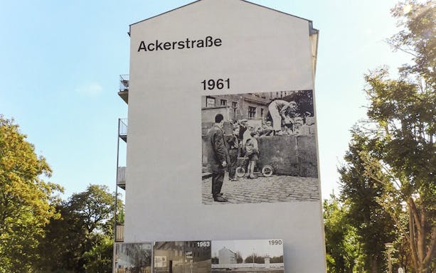 Mural on Ackerstraße depicting Berlin Wall escape scene from 1961, part of Mauer Tour.