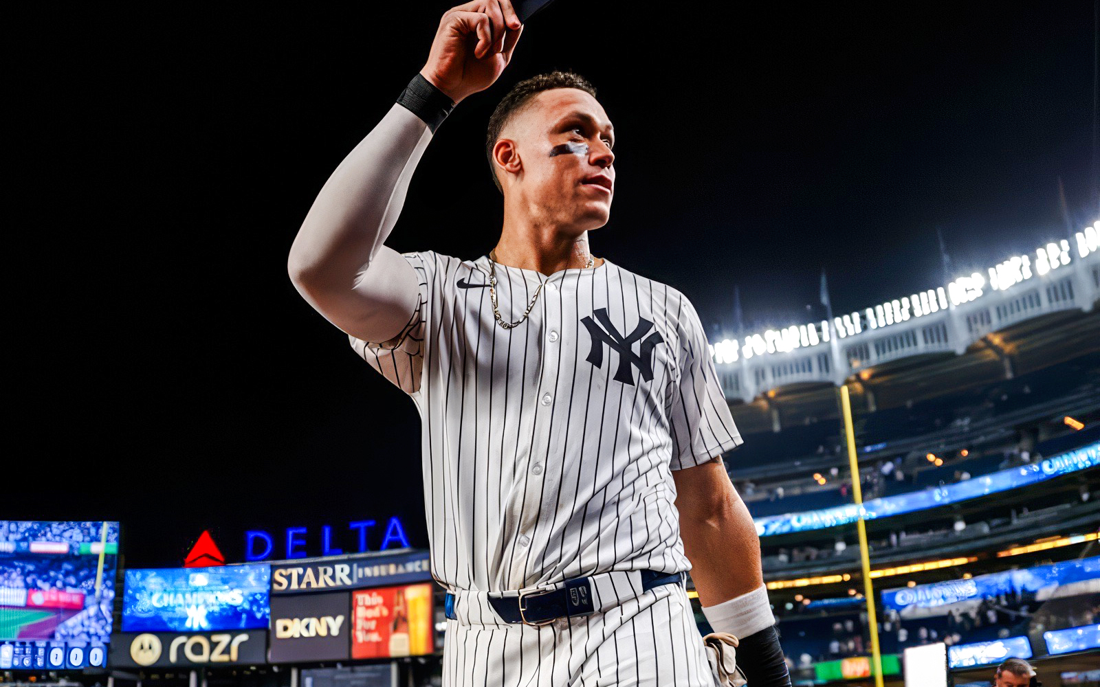 Baseball player in Yankees uniform at Yankee Stadium during the Classic Stadium Tour.