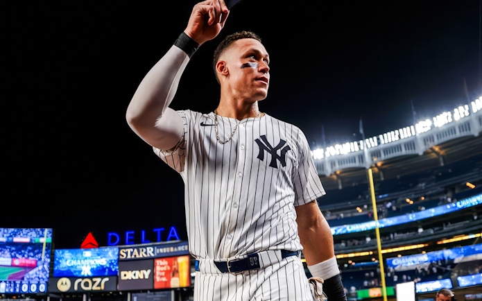 Baseball player in Yankees uniform at Yankee Stadium during the Classic Stadium Tour.