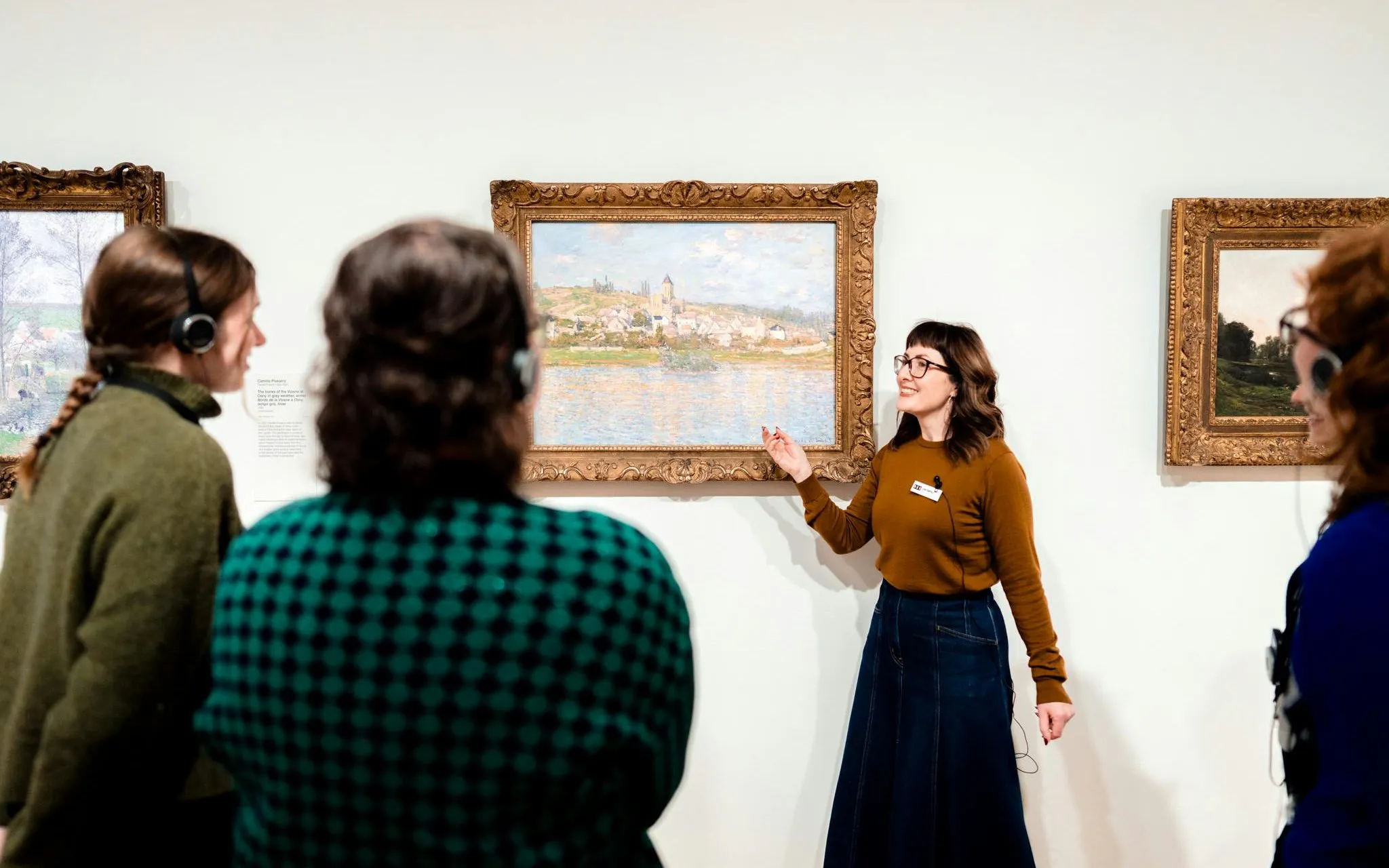 Tour guide explaining artwork to visitors at National Gallery of Victoria.