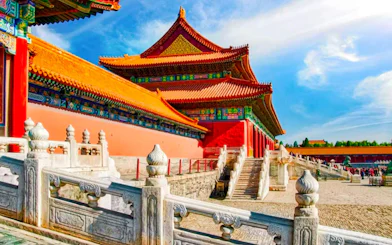 Palace Museum in Beijing with red walls, yellow-tiled roofs, and white marble balustrade.