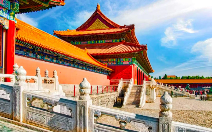 Palace Museum in Beijing with red walls, yellow-tiled roofs, and white marble balustrade.