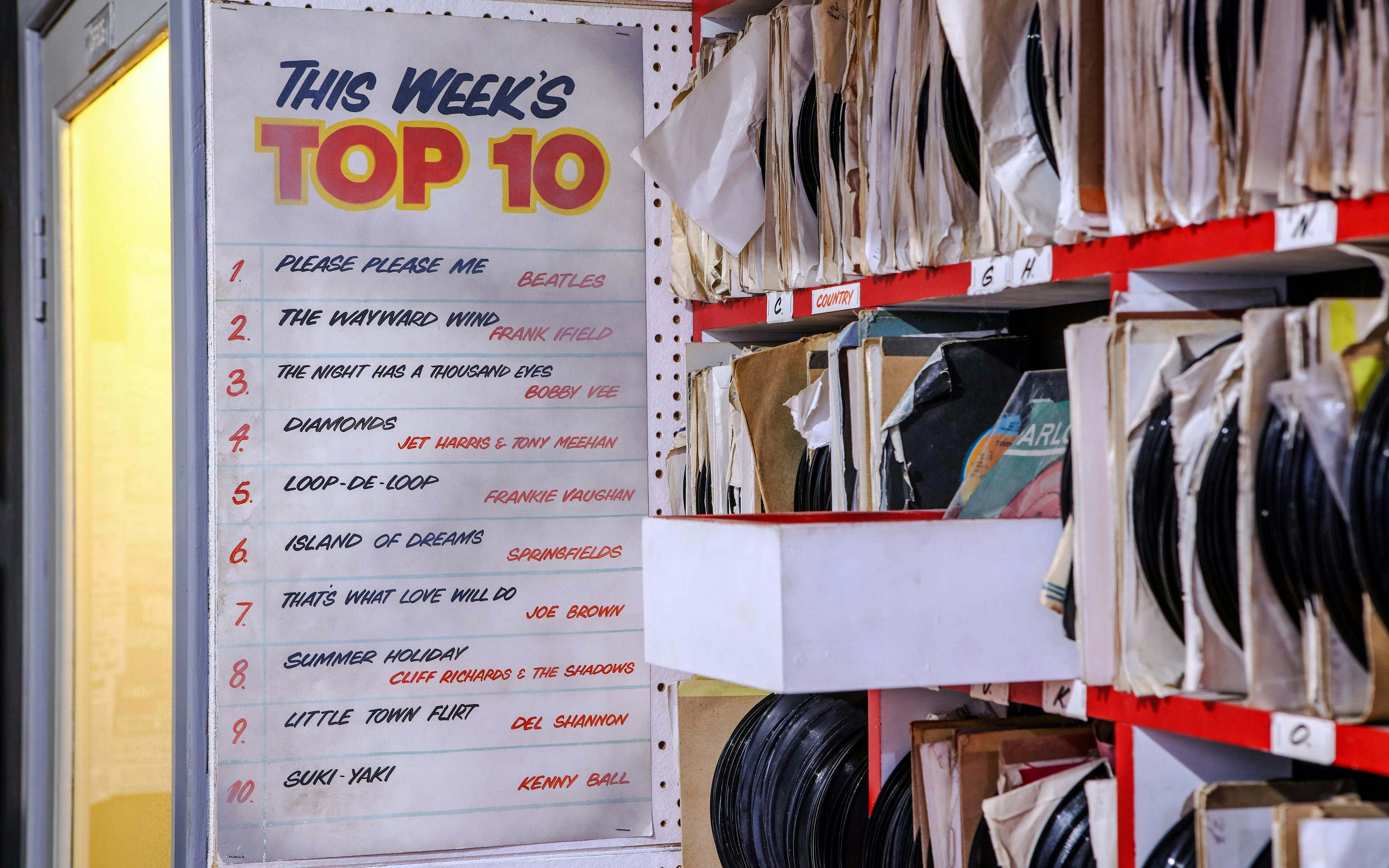 Top 10 chart and vinyl records at The Beatles Story exhibit.