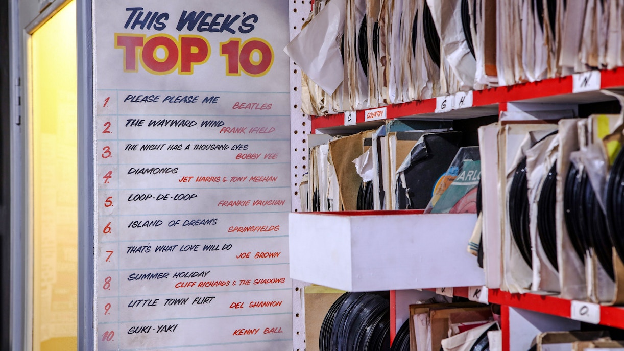 Top 10 chart and vinyl records at The Beatles Story exhibit.