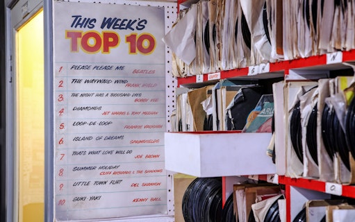 Top 10 chart and vinyl records at The Beatles Story exhibit.