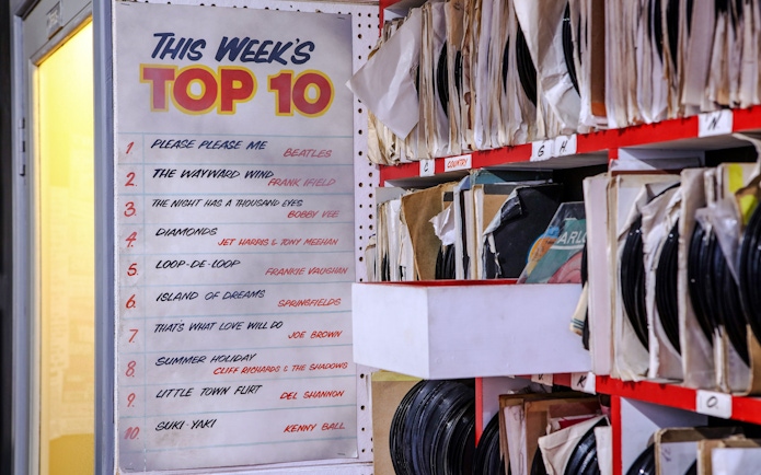 Top 10 chart and vinyl records at The Beatles Story exhibit.