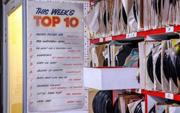 Top 10 chart and vinyl records at The Beatles Story exhibit.