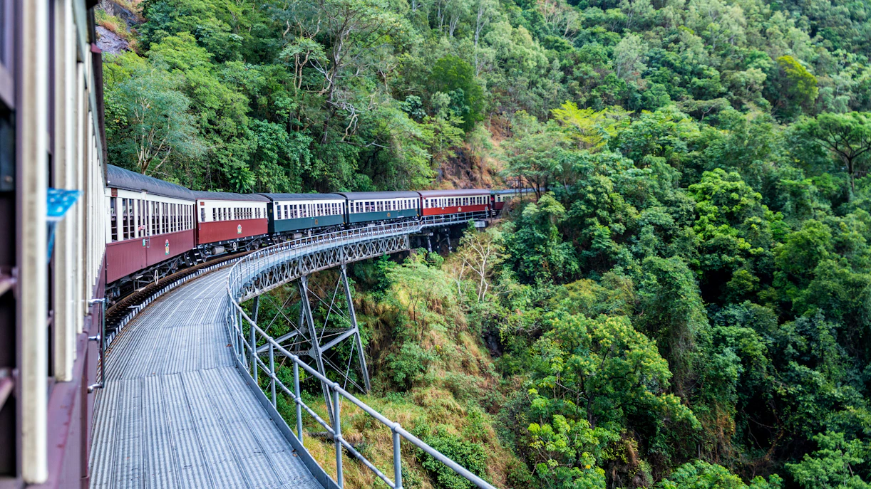 Kuranda scenic railway winding through lush green forests in Australia.