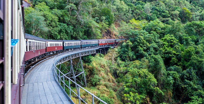 Kuranda scenic railway winding through lush green forests in Australia.