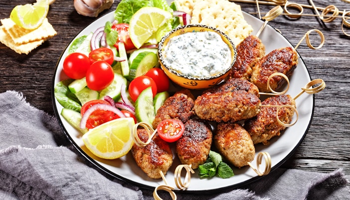 Lamb kleftiko skewers with salad and tzatziki at a Delphi restaurant.