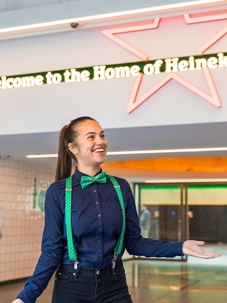 Tourists with guide at Heineken Experience entrance in Amsterdam.