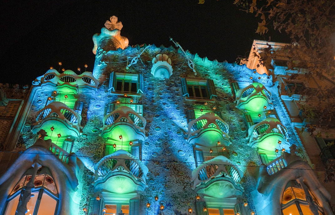 Casa Batlló illuminated at night in Barcelona, showcasing its unique architectural design.