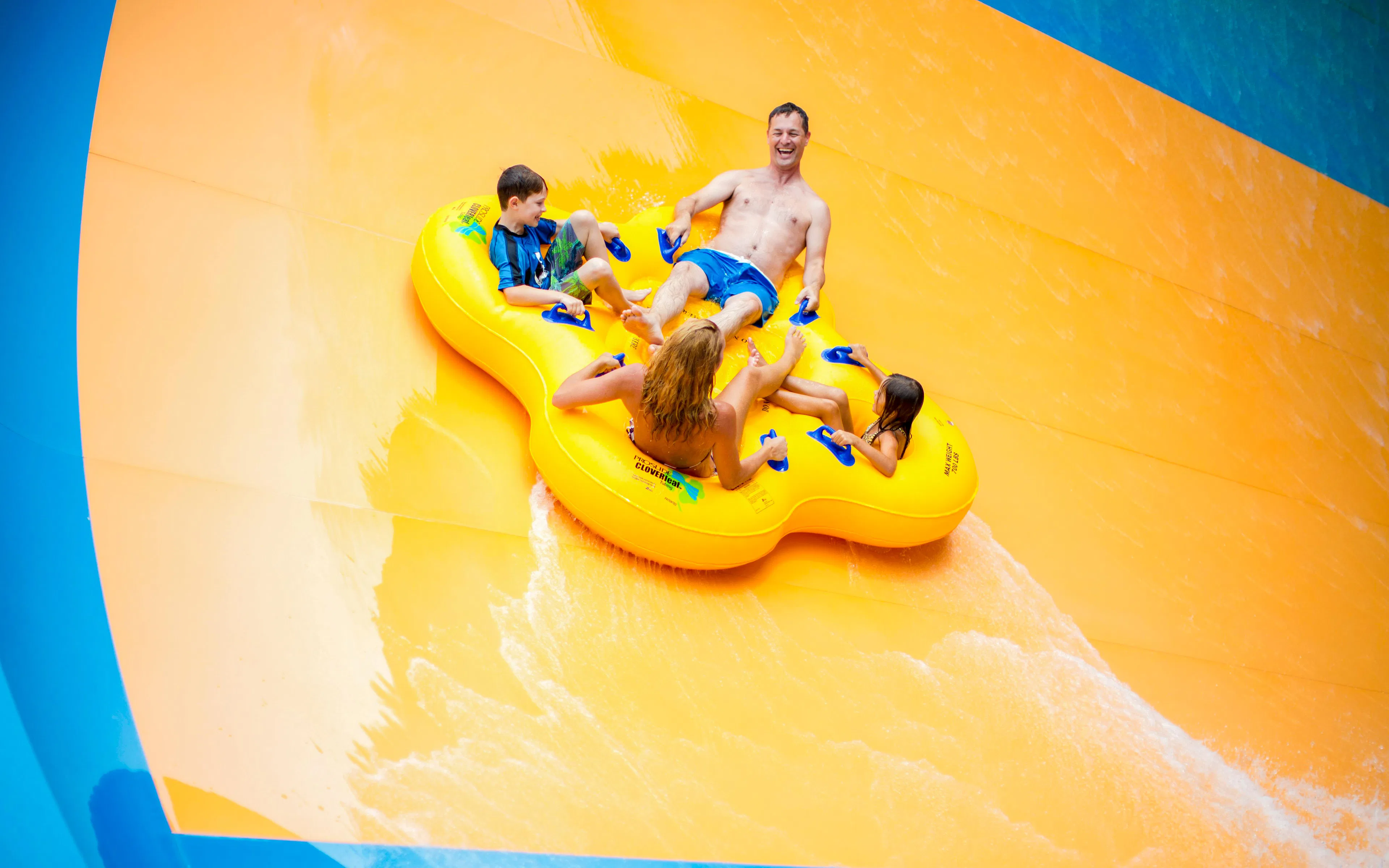 Group enjoying water slide at Tornado, Hurricane Harbor Arlington.