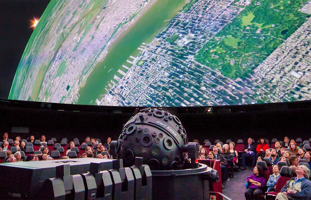 Visitors at the American Museum of Natural History viewing the Milky Way exhibit via Zeiss projector.