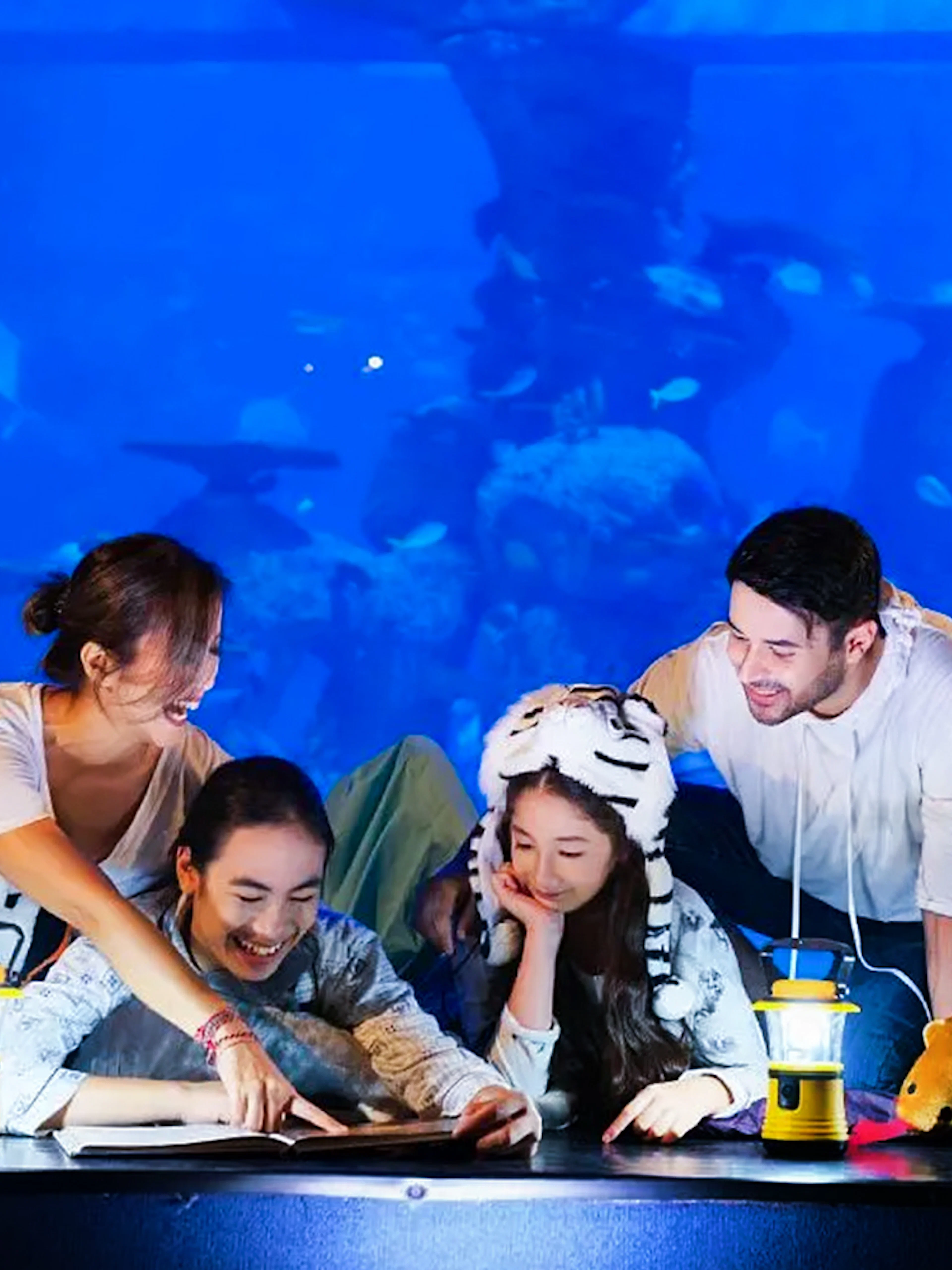 Family enjoying interactive exhibit at Jakarta Aquarium Safari.