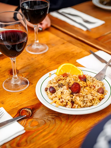 Arroz de Fumeiro dish with wine during Lisbon Food Walk in Baixa.