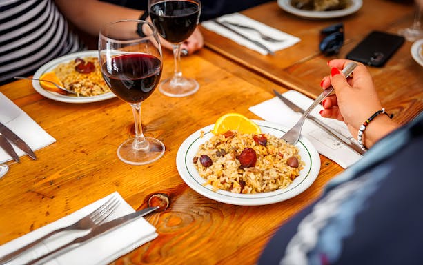 Arroz de Fumeiro dish with wine during Lisbon Food Walk in Baixa.