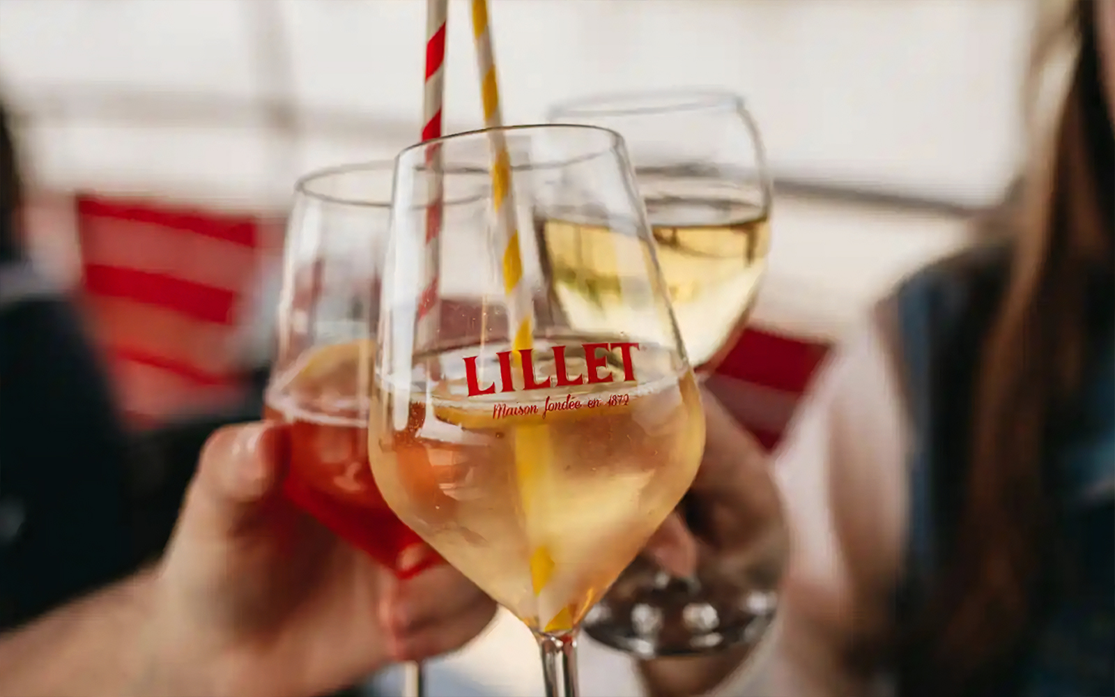 Glasses of Lillet being toasted on a Bordeaux River Cruise welcome event.