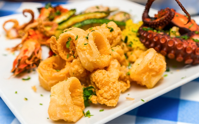 Fried calamari and grilled octopus platter, Jimbaran Bali seafood dinner.