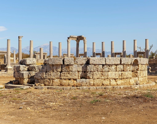 Ancient agora ruins in the Greek city of Neapolis with stone columns and pathways.