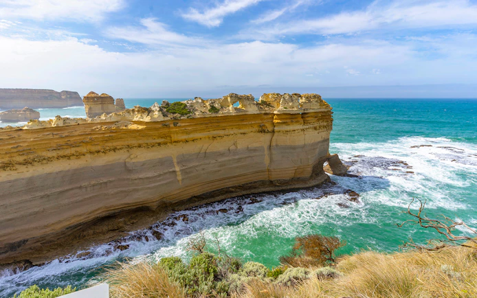 Razorback rock formation along the Great Ocean Road with ocean waves below.