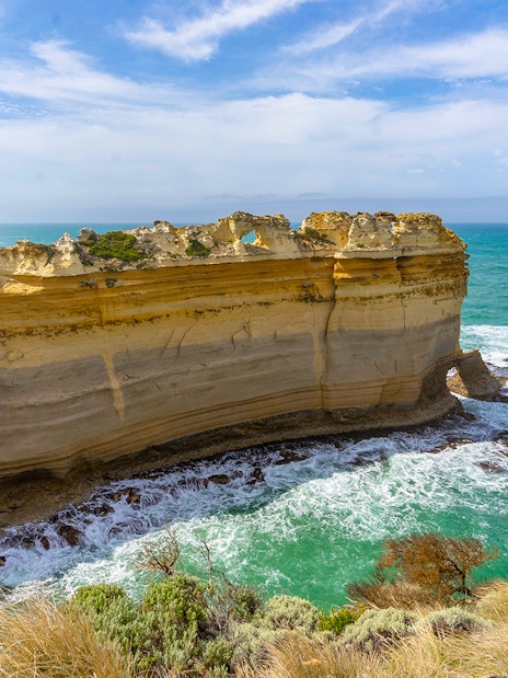 Razorback rock formation along the Great Ocean Road with ocean waves below.