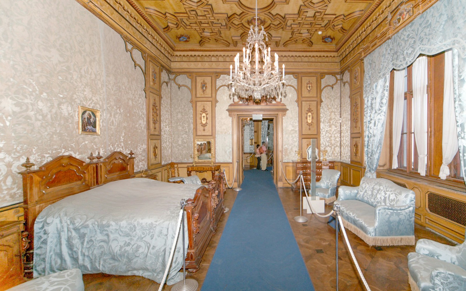 Miramare Castle bedroom with ornate bed and historical furnishings in Trieste, Italy.