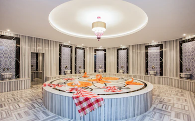Marble interior of Hammam Bath and Spa in Cappadocia with ornate tiles and central platform.