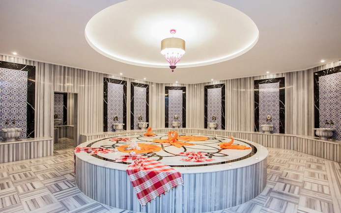 Marble interior of Hammam Bath and Spa in Cappadocia with ornate tiles and central platform.