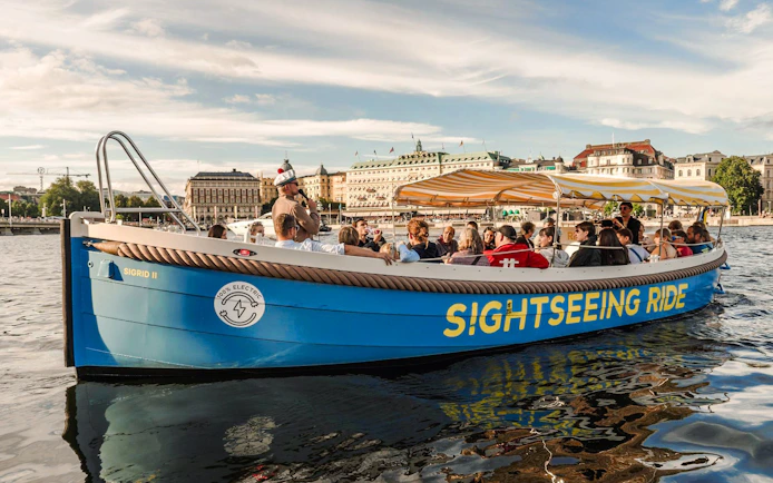 Sightseeing boat tour with passengers on Stockholm's waterfront.