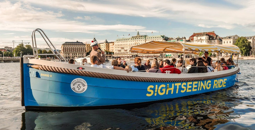 Sightseeing boat tour with passengers on Stockholm's waterfront.