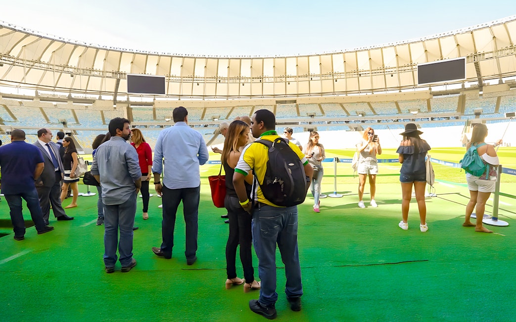 Tourists exploring the field of Maracanã Stadium, Brazil.