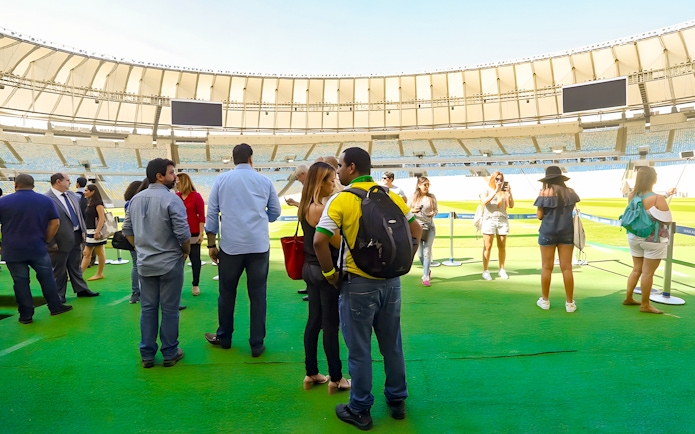 Tourists exploring the field of Maracanã Stadium, Brazil.
