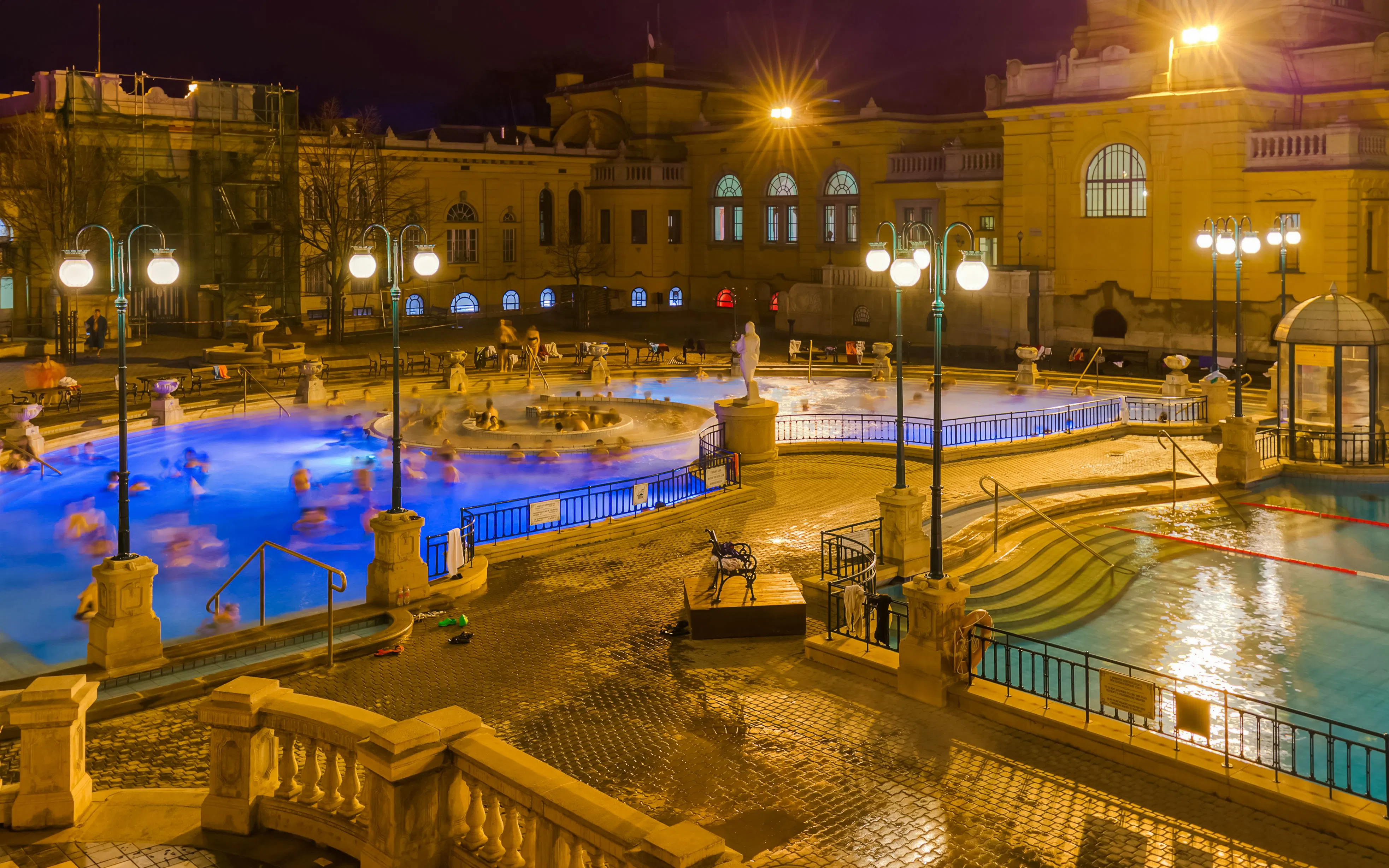 Szechenyi Thermal Bath pools illuminated at night in Budapest, Hungary.