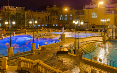Szechenyi Thermal Bath pools illuminated at night in Budapest, Hungary.