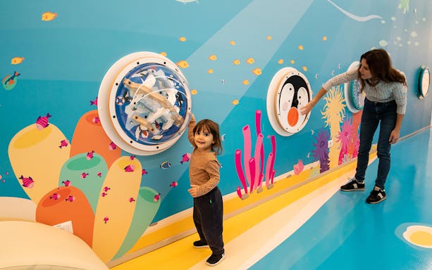 Child exploring interactive wall at The City of Children and Youth.
