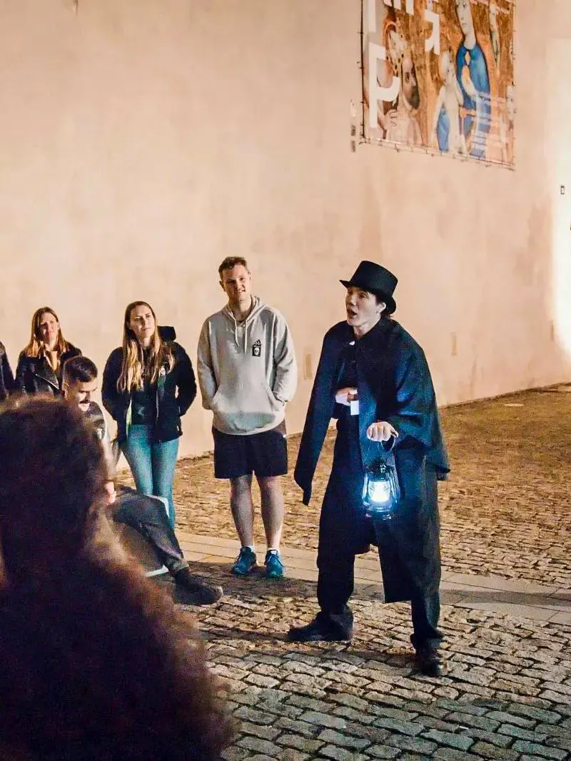 Guide holding lantern during Ghosts & Legends tour in Old Town Prague.