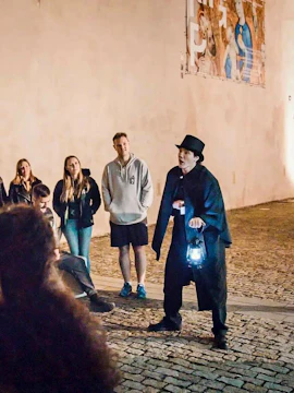 Guide holding lantern during Ghosts & Legends tour in Old Town Prague.