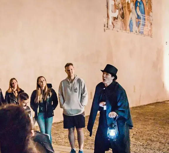Guide holding lantern during Ghosts & Legends tour in Old Town Prague.