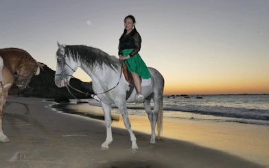 Horseback rider on beach at sunset, Tangier coastal trail, Mnar region.