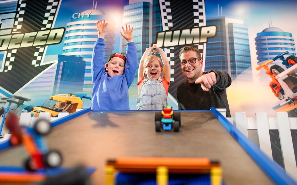 Kids enjoying toy Lego car race at LEGOLAND Discovery Centre Oberhausen.