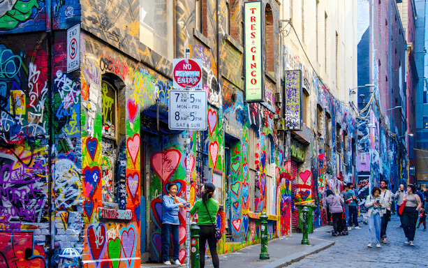 Visitors exploring vibrant street art on Hosier Lane, Melbourne.