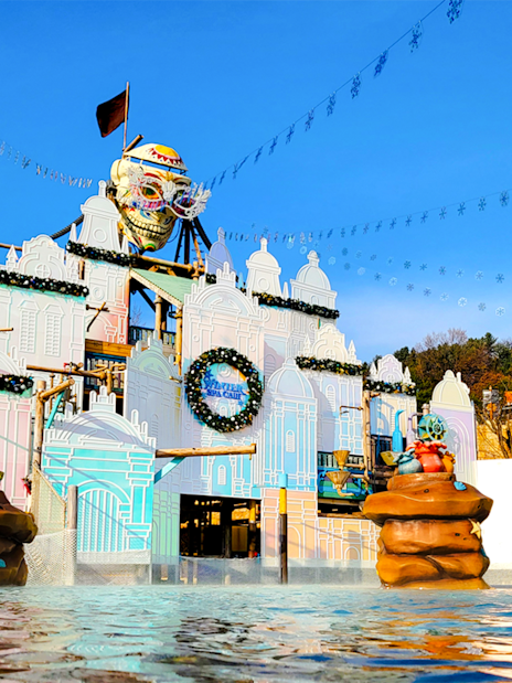 Caribbean Bay Water Park entrance with colorful facade and water features.