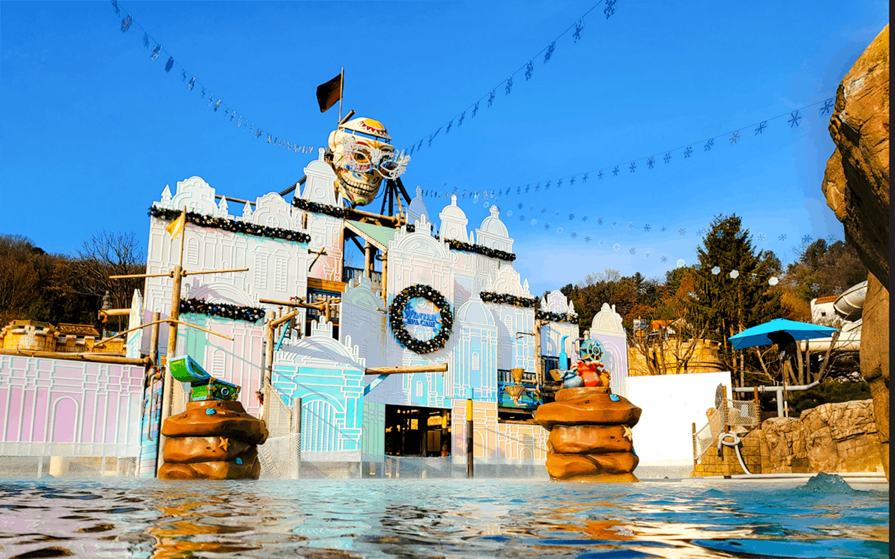 Caribbean Bay Water Park entrance with colorful facade and water features.