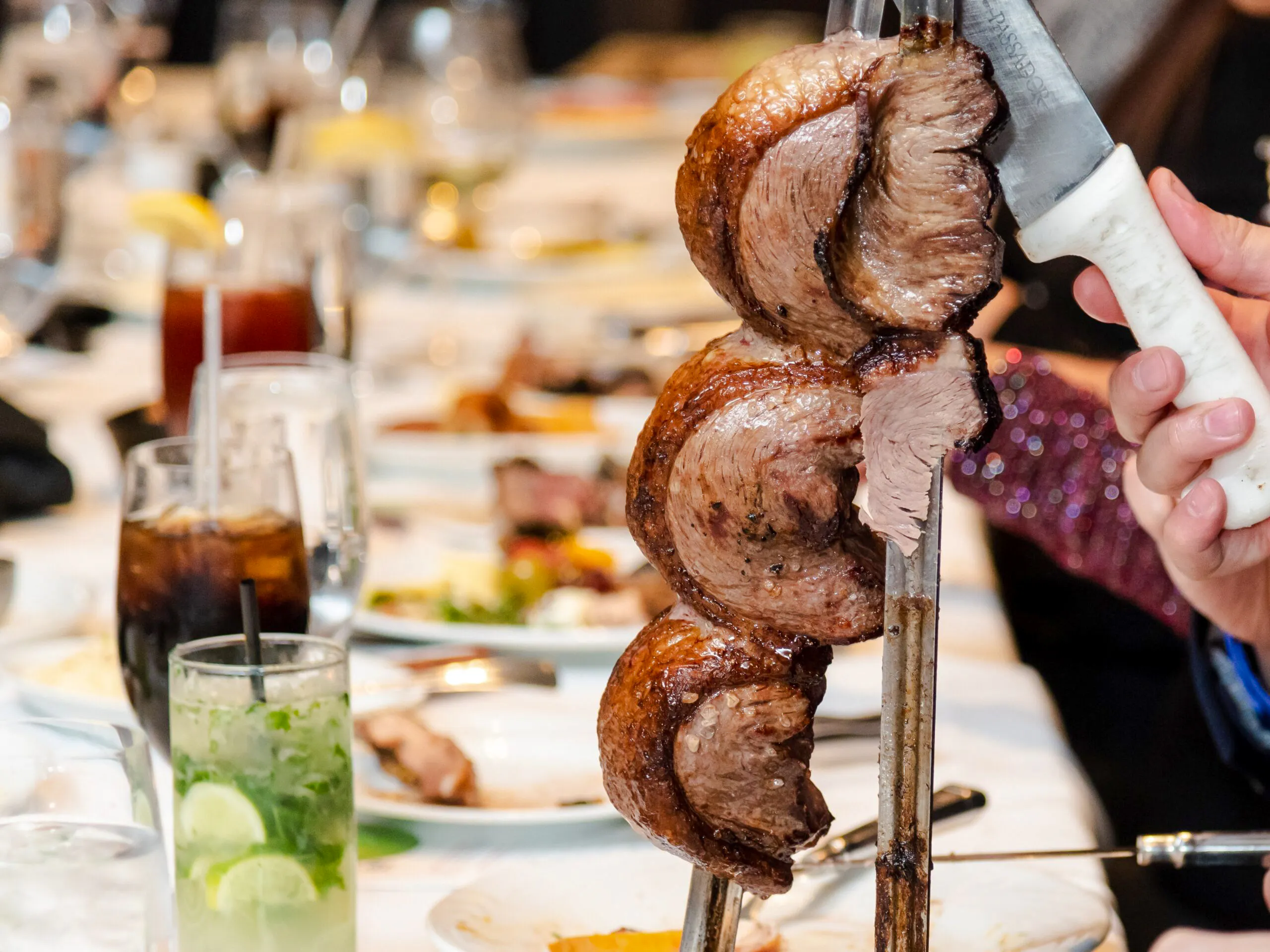 Skewered meat being served at a Brazilian steakhouse in Rio de Janeiro.