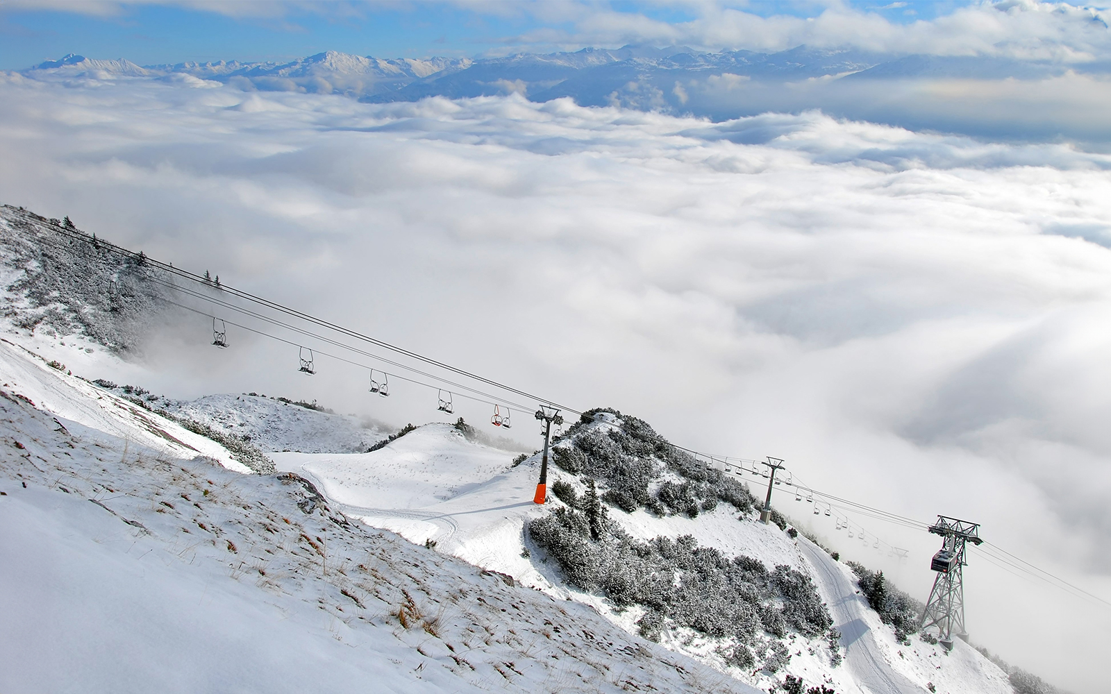 Nordkettenbahn cable car ascending snowy mountain in Innsbruck, Austria.