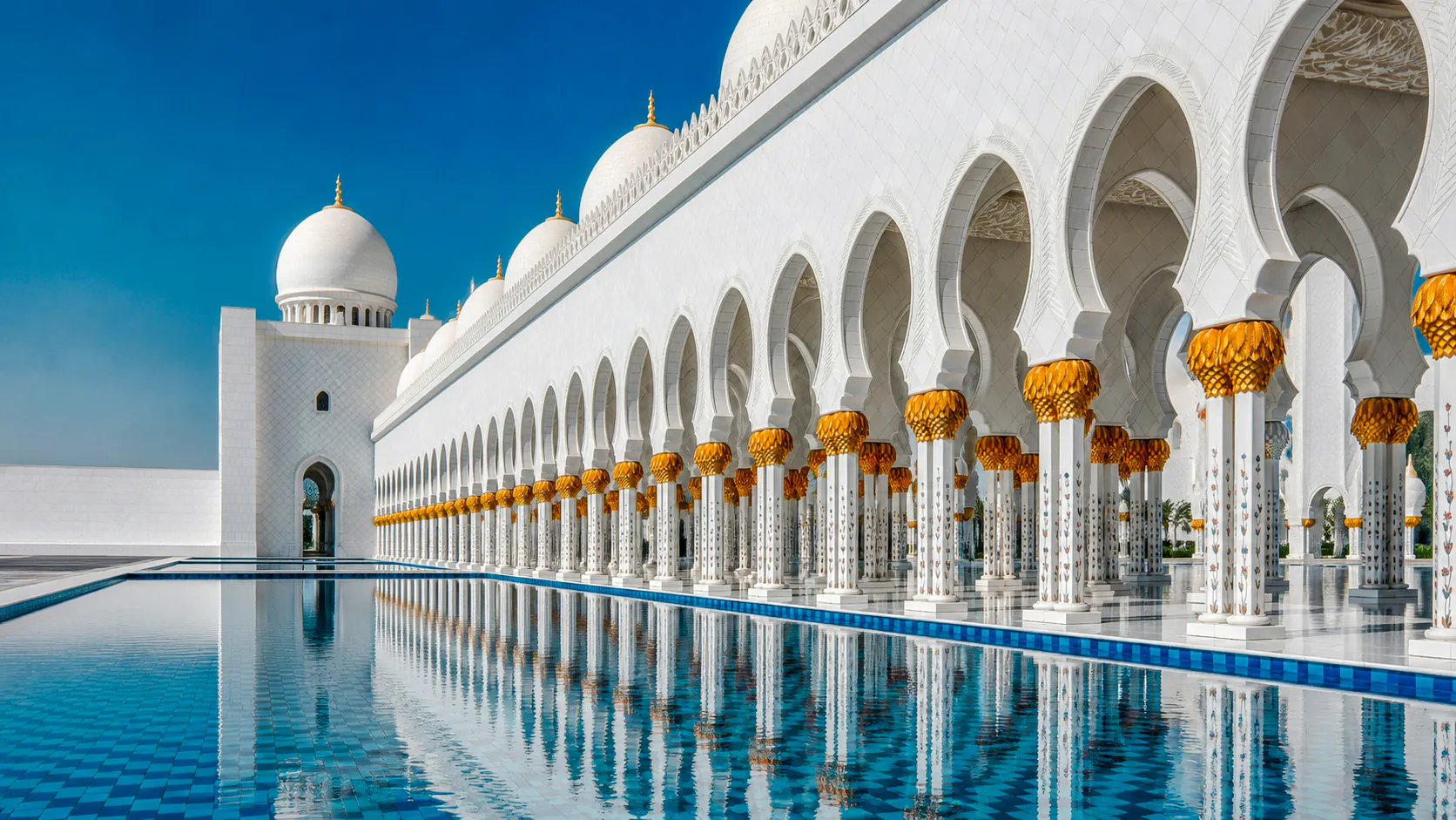 Sheikh Zayed Grand Mosque arches and reflection in Abu Dhabi.