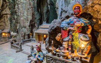 Shrine with statues inside Huyền Không Cave, Marble Mountains, Đà Nẵng.