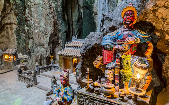 Shrine with statues inside Huyền Không Cave, Marble Mountains, Đà Nẵng.